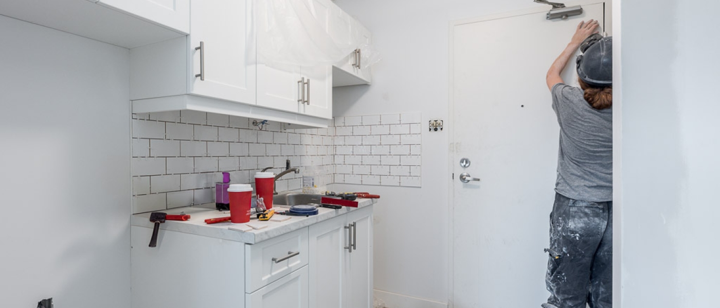 Photo of a man doing renovation work at a co-op