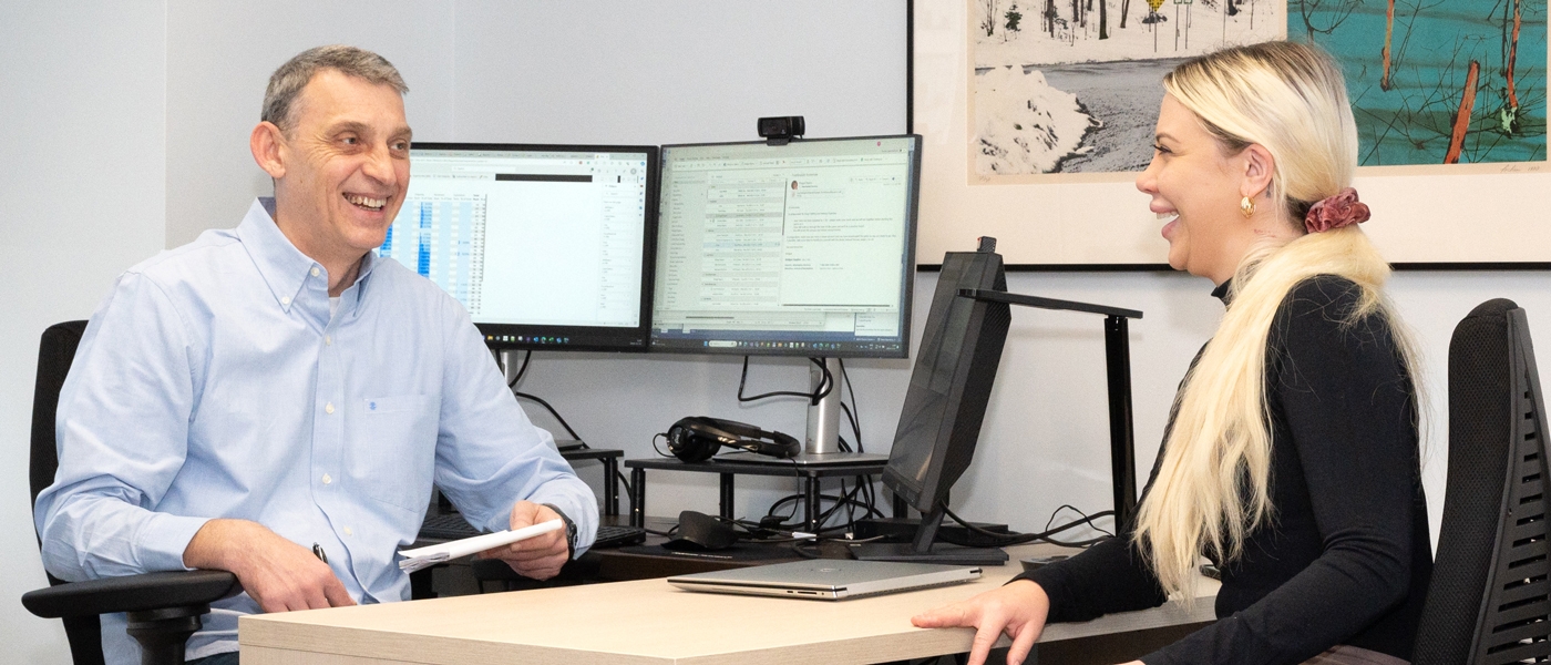Photo of 2 Agency staff members working together